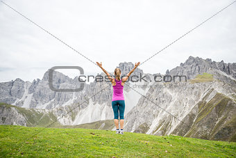 young woman on top of the mountain