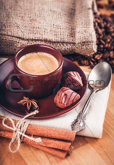 Cup fragrant hot coffee with bean chocolate