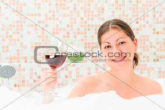 girl with a glass of wine in the foam