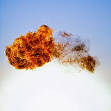 Fireball explosion on blue sky background