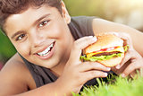 Happy boy eating burger