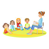 Group Of Small Kids Sitting Around The Teacher Reading A Story