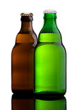 Green and brown beer bottles with dew on white