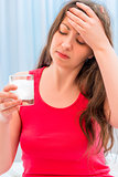 girl holding a glass of dissolving drug