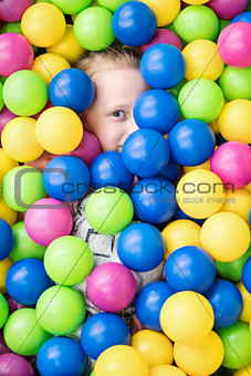 Child completely hid in colorful balls