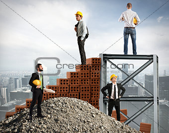 Businessmen work together to build a building