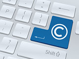 Copyright concept on button of white computer keyboard.