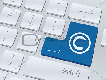 Copyright concept on button of white computer keyboard.