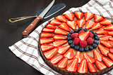 Delicious chocolate tart decorated with fresh berries