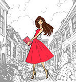 Fashionable cute girl in pink dress walking down the street