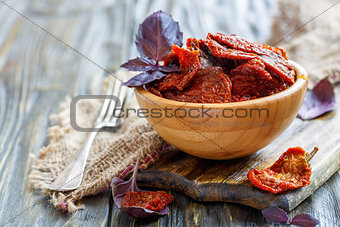 Bowl with sun-dried tomatoes and fork.