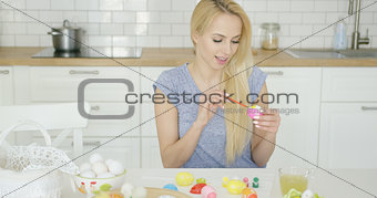 Beautiful girl painting on Easter eggs