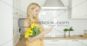 Lovely female with flowers and phone