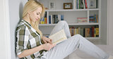Lovely female reading at home