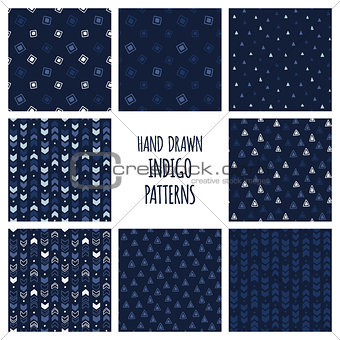 Set of hand drawn indigo blue patterns. Seamless vector triblal backgrounds with triangles and arrows.