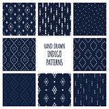 Set of hand drawn indigo blue patterns. Seamless vector aztec backgrounds with triangles, arrows, rhombuses and diamonds.
