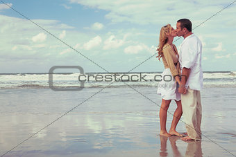 Romantic Man and Woman Couple Kissing On A Beach