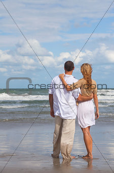 Rear View of Romantic Man and Woman Couple On A Beach