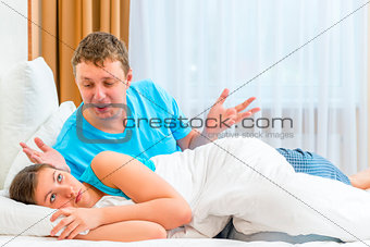 couples quarrel in the morning in bed