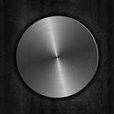 Brushed metal button on a grunge background