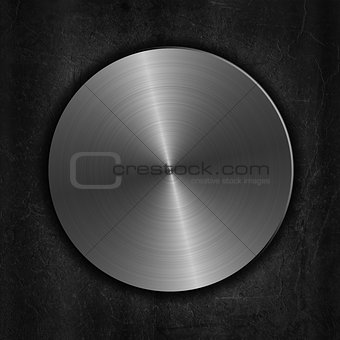 Brushed metal button on a grunge background
