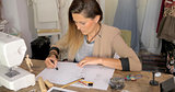 Female dressmaker drawing sketches