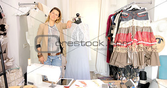 Smiling tailor with mannequin