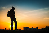 Traveler silhouette watching amazing sunset