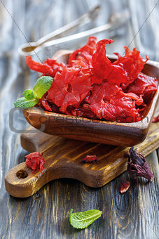 Wooden bowl with dried hibiscus flowers.