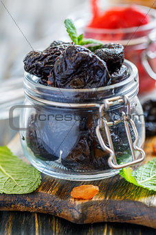 Dried prunes in a glass jar.