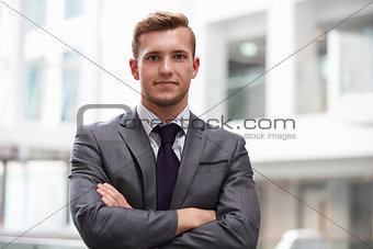 Head And Shoulders Portrait Of Young Businessman In Office