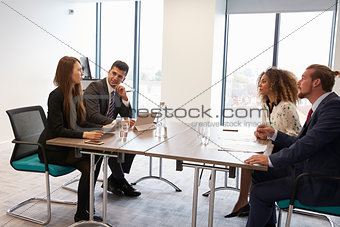 Businesspeople Working Together At Desk In Modern Office