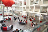 Students in a modern university atrium, view from mezzanine