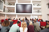 Back view of students at a lecture in a university atrium