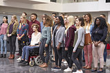 Student group standing in university atrium looking away