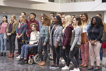 Student group standing in university atrium looking away