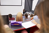 Woman lecturing students in a lecture theatre, student POV