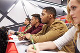 Students listening to lecture at university lecture theatre