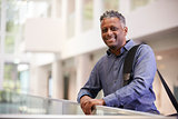 Middle aged black man  smiling in modern building lobby