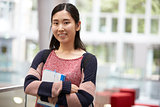 Asian female adult student in a modern university lobby