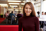 Portrait Of Female University Student Working In Library