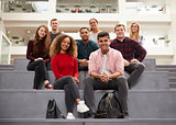 Portrait Of Student Group On Steps Of Campus Building