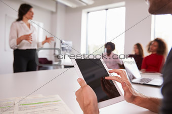 Close Up Of Student Using Digital Tablet In Lecture