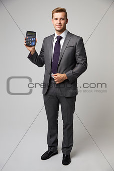 Studio Portrait Of Accountant Using Calculator