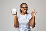 Studio Portrait Of Female Accountant Using Calculator