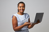 Studio Portrait Of Businesswoman Using Laptop