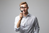 Portrait Of Male Criminologist With Magnifying Glass