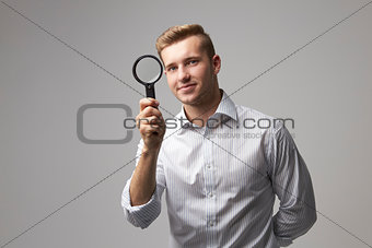 Portrait Of Male Criminologist With Magnifying Glass