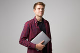 Studio Portrait Of Casually Dressed Businessman With Laptop