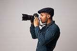 Studio Portrait Of Male Photographer With Camera